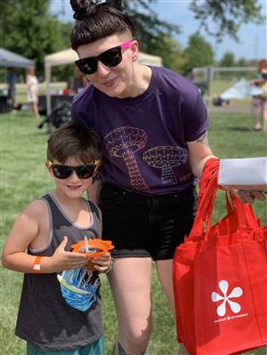 A photo of Kidchella attendees, a mother and son smiling.